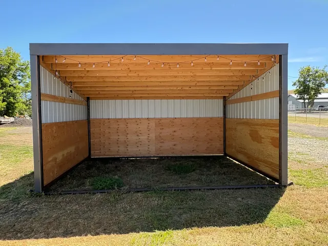 Open-front metal livestock shelter with timber framing